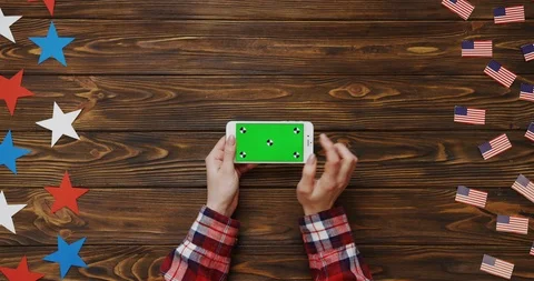 Top view on the woman's hands scrolling and taping on the white smartphone with Stock Footage 91727962