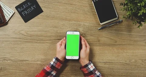 Top view on the woman's hands using the white vertical smartphone with a green Stock-Footage 89955782