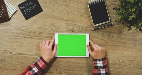 Top view on the woman's hands using the white horizontal tablet device with a Video stock 89957020