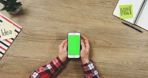 Top view on the woman's hands using the white vertical smartphone with a green 스톡 동영상 89959756