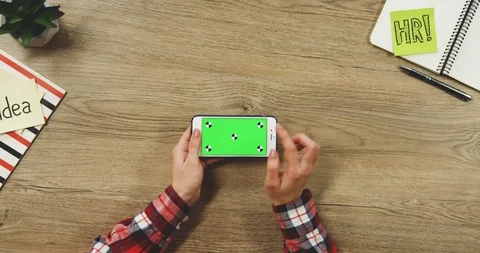 Top view on the woman's hands using the white horizontal smartphone with a green Stock Footage 89960023