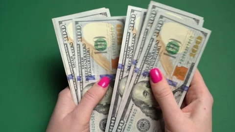 Top view of women's hands counting a stack of U.S. dollar bills. Stock Footage 235850856