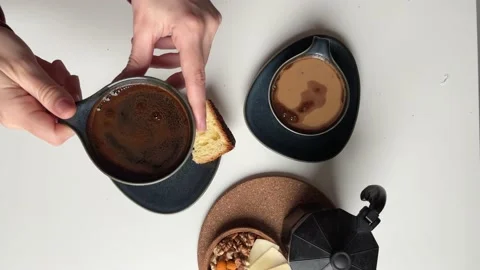 Top view women's hands taking a cup of coffee on the table Geyser coffee maker Stock Footage 238944268