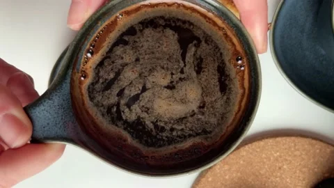 Top view women's hands taking a cup of coffee on the table Geyser coffee maker Stock Footage 238944283