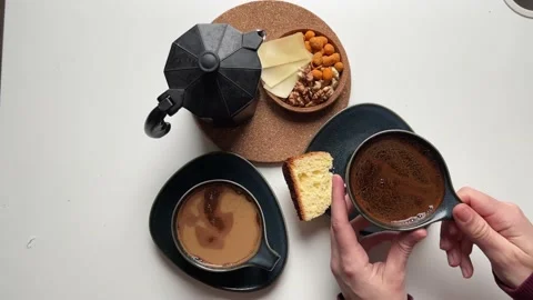 Top view women's hands taking a cup of coffee on the table Geyser coffee maker Stock Footage 238944339