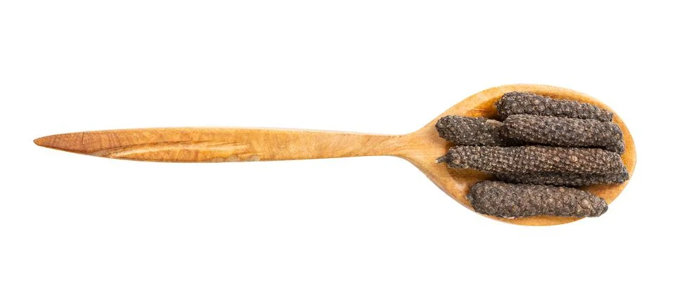 Top view of wood spoon with java long peppers Photos