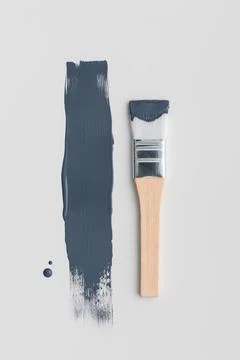 Top view of a wooden paint brush with fresh navy blue color smear. Minimalist Stock Photos