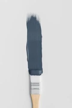 Top view of a wooden paint brush with fresh navy blue color smear. Minimalist Stock Photos