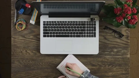 Top view of wooden table with office supplies. Stock Footage 74471889