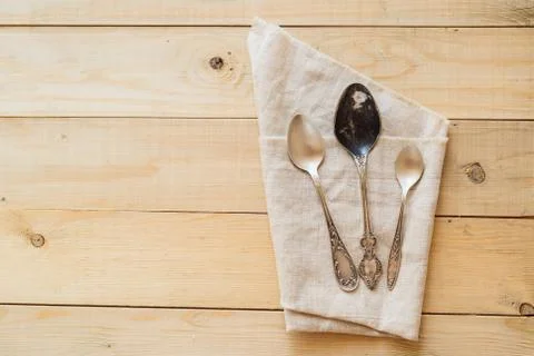 Top view wooden table setting with copyspace, three antique spoons Stock Photos