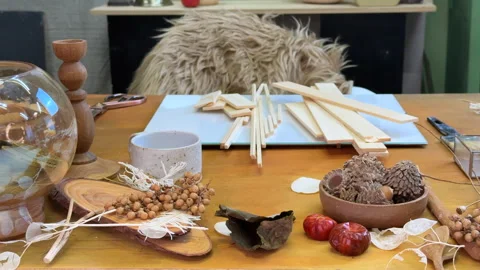Top view of a wooden table with tools and natural materials for autumn collage m Video stock 312639665