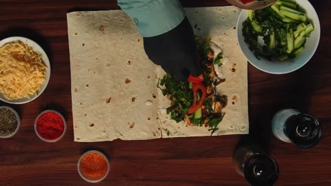 Top view of a wooden table on which shawarma is being prepared Stock Footage 318617830
