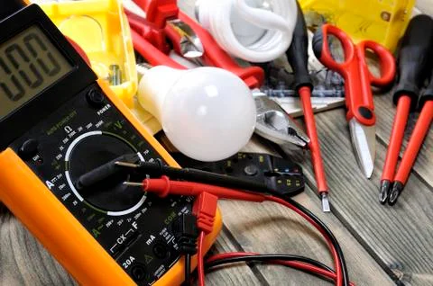 Top view of work tools and electrical system components on rustic wooden back Stock Photos