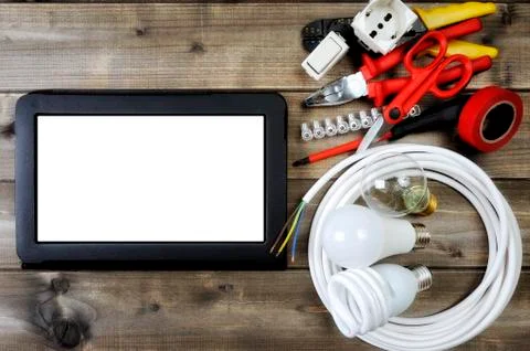 Top view of work tools and electrical system components on wooden background Stock Photos