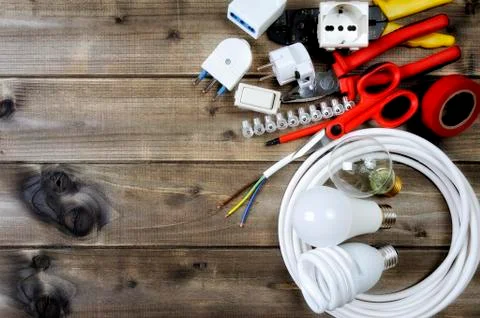 Top view of work tools and electrical system components on wooden background Stock Photos
