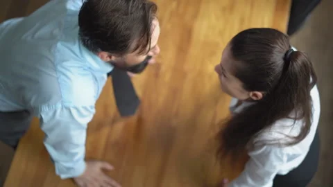 Top view. Work violence. A man yells at a subordinate leaning on the table. The Stock Footage 131866413
