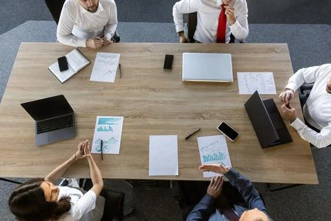 Top view work workplace. A team of young office workers, businessmen with laptop Stock Photos