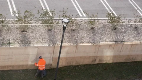 Top View Of A Worker Collecting Waste In The Flowerbeds. 4K Stock-Footage 233378956