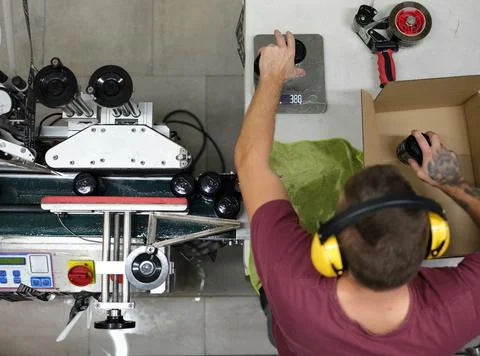 Top view of a worker packing cans of beer for a deliver in a craft beer factory Stock Photos