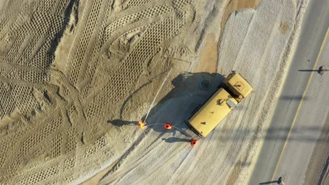 Top view on worker as splashing water over sand at building site Vídeos de archivo 197302901