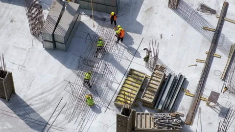 Top view: workers assembling a metal rebars at the construction site Video stock 236474003