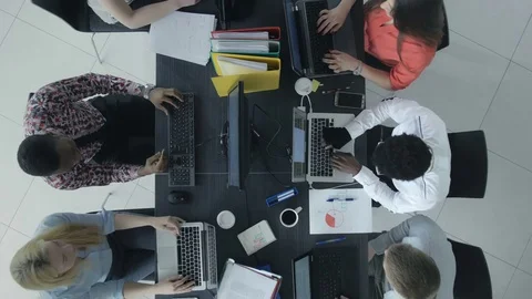Top view of workers at the desk in the office Stockbeeldmateriaal 73846930