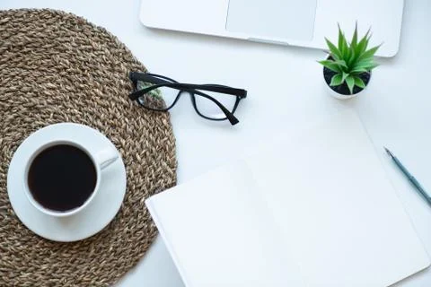 Top view working space with laptop, plant, cup of coffee , notebook, pen and Stock Photos