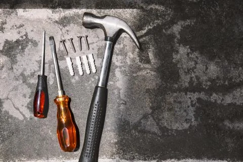 Top view working tools, hammer, screwdrivers and plastic anchors on cement 写真素材
