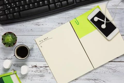 Top view of a workplace with open empty notebook Stock Photos