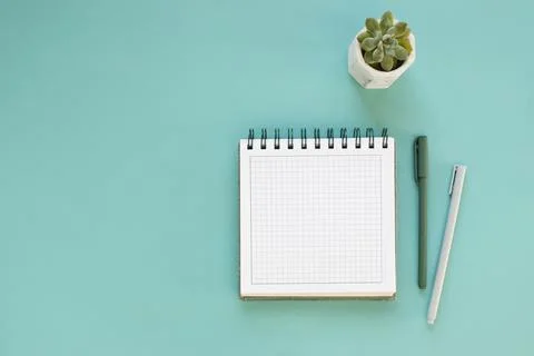 Top view of workspace and opened notebook with mock up blank pages Stock Photos