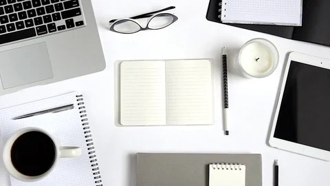 Top view of workspace with laptop, tablet, other objects with notebook in center Stock Footage 72037097