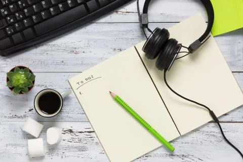 Top view of a workspace with open empty notebook. Stock Photos