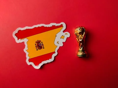 Top view world cup trophy with spain flag stickers on a red background Stock Photos