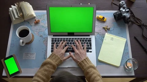 Top view. World map on the table, a woman planning a vacation. Stock Footage 84895381