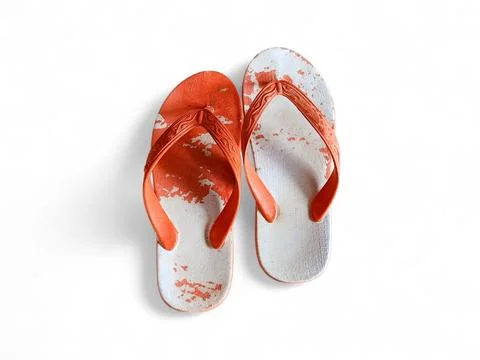 Top view of worn flip flops with peeling white surface and visible damage Foto stock