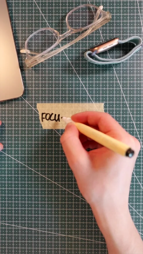 Top view of writing FOCUS MODE on masking tape with gadget accessories Stock Footage 338183616