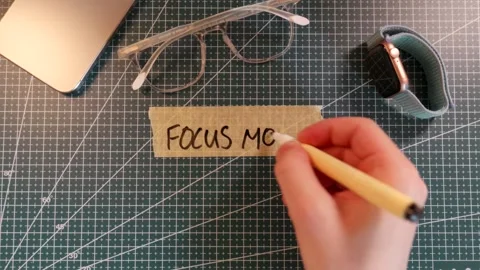 Top view of writing FOCUS MODE on masking tape with gadget accessories Stock Footage 338183907