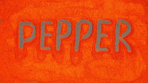 TOP VIEW: Writing of Pepper word on a red pepper background - Stop motion Видео 90239852