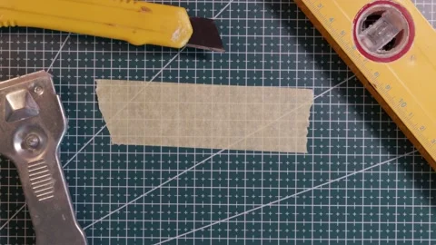 Top view of writing SAFETY FIRST on masking tape with tools. Stock Footage 337816345