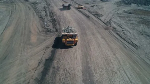 Top view of yellow dump truck with garbage rock in coal mining. Road to Stock Footage 203917571