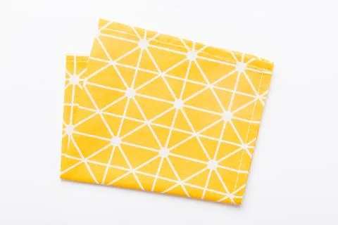 Top view with yellow empty kitchen napkin isolated on table background. Folde Stock Photos