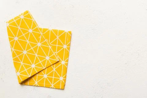 Top view with yellow empty kitchen napkin isolated on table background. Fol.. Stock Photos