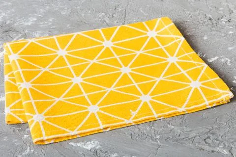Top view with yellow empty kitchen napkin isolated on table background. Folde Stock Photos