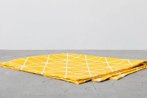 Top view with yellow empty kitchen napkin isolated on table background. Folde Stock Photos