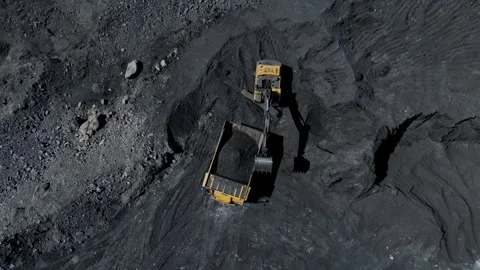 Top view of a yellow excavator operating in a deep coal mine with intricate Stock Footage 275010116