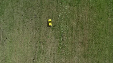 Top view of a yellow retro car ride through the green spring meadow Stock-Footage 237989155