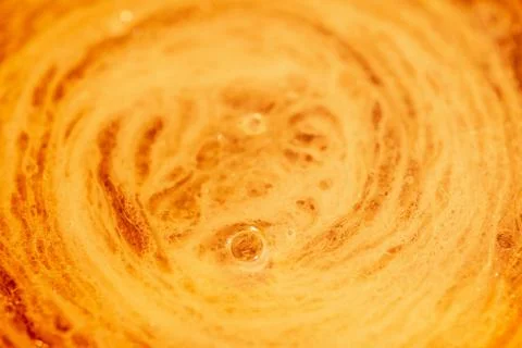 Top view of yellow soft drink and white foam. Stock Photos
