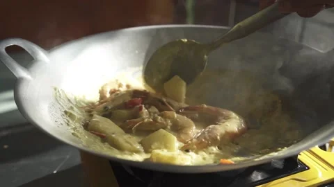 Top View of Yellow Thai Curry Cooking on a Large Frying Pan Wok in the Kitchen. Stock Footage 133364381