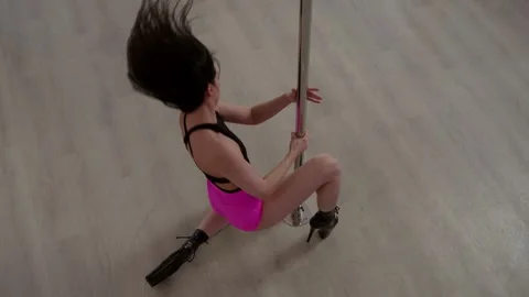 A top view of a young and attractive woman, dancing near a pole. Stock Footage 305272501