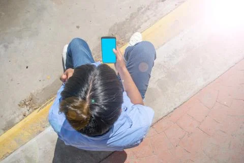 Top view of young blogger using his cell phone 库存照片
